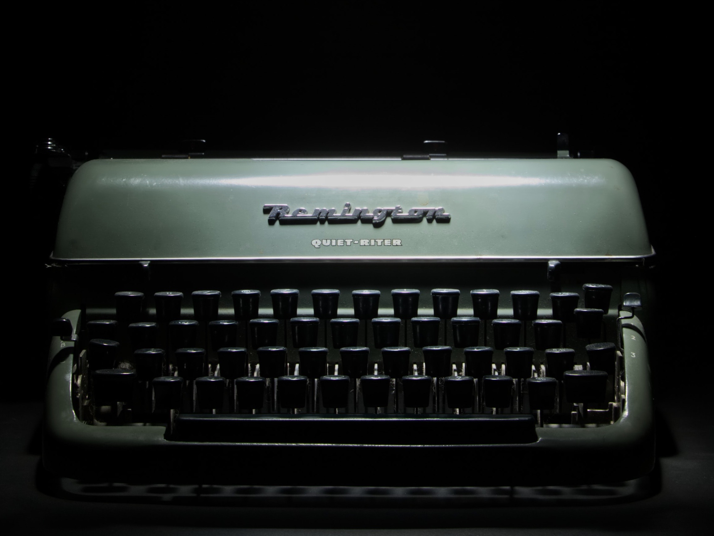 Green Remington typewriter with black keys.